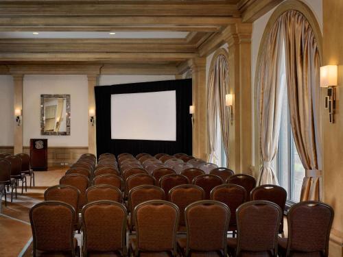 a conference room with a bunch of chairs and a screen at The Royal Sonesta Harbor Court Baltimore in Baltimore