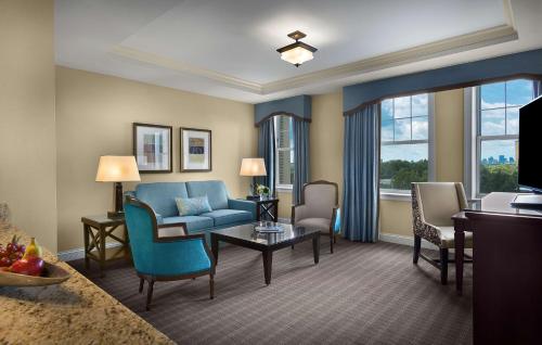 a living room with a blue couch and chairs at The Royal Sonesta Chase Park Plaza St Louis in Saint Louis