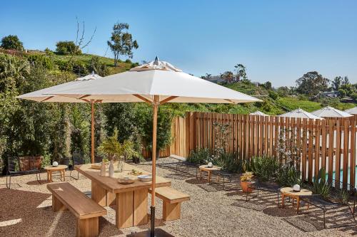 a patio with a table and an umbrella at Hotel June Malibu in Malibu