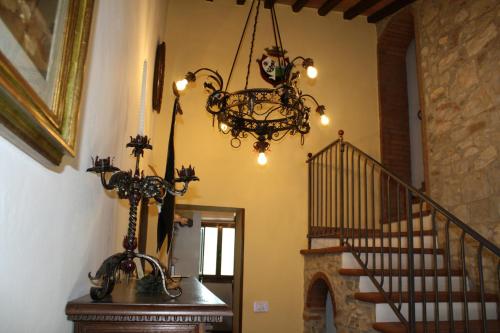 a chandelier hanging in a room with a staircase at Agriturismo Borgo Il Bonagino in Radda in Chianti