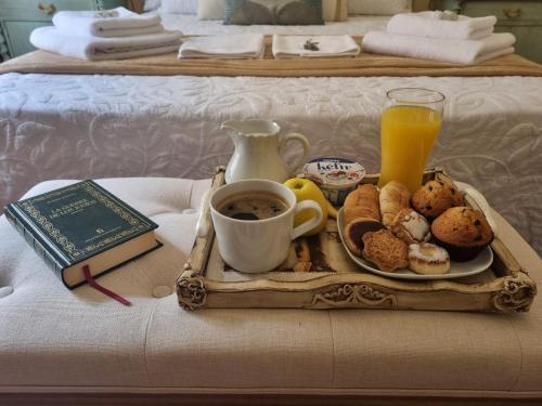 a tray of food and a cup of coffee on a bed at Casa de Lorca in Alcalá de Henares