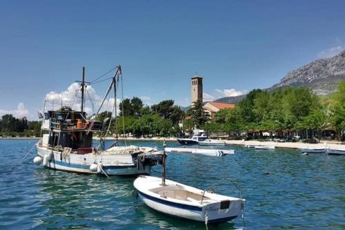 a group of boats docked in a body of water at Stone house Castellum in Kaštela