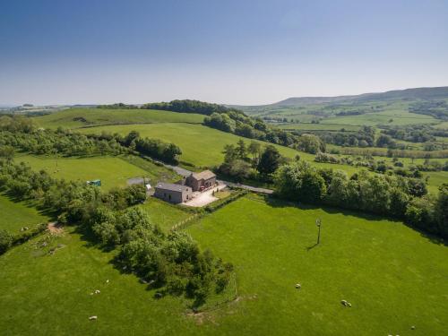 an aerial view of a house in a green field at Clerk Laithe Lodge in Newton