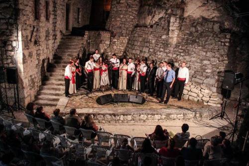 a group of people standing on a stage at Stone house Castellum in Kaštela