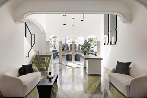 a living room with two chairs and a table at Casa Polanco Hotel Boutique in Mexico City