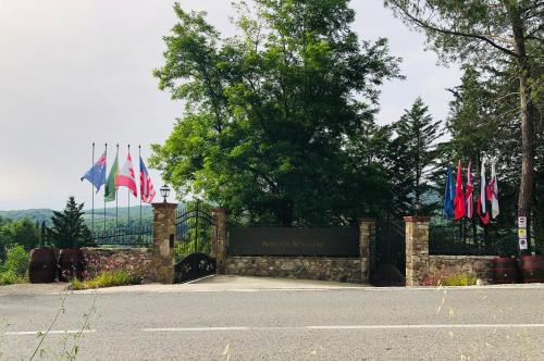 a gate with flags in front of a building at Agriturismo Borgo Il Bonagino in Radda in Chianti