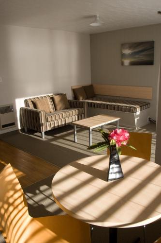 a living room with a table and a couch at Akaroa Waterfront Motels in Akaroa