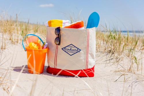 a bag on the beach with a basket of fruit at Windward at the Beach in Beach Haven