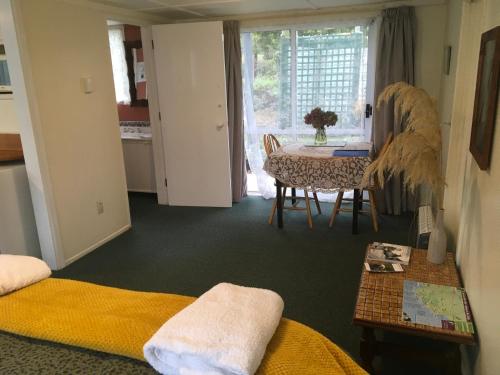 a living room with a table and a dining room at Kepplestone by the Sea - The Catlins in New Haven