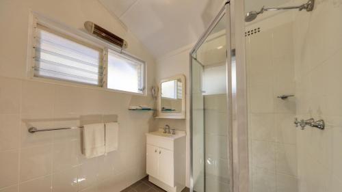 a bathroom with a shower and a sink at Cowra Motor Inn in Cowra