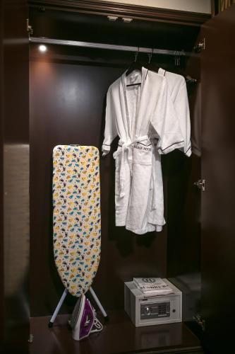 a closet with a shirt and a tie on a rack at Halais Hotel in Hanoi