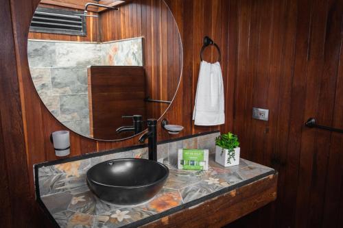 a bathroom with a sink and a large mirror at Glamping The Mountain in Guatapé