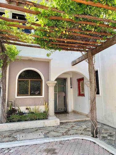 a building with an archway and a building at Mexican Lagoon front Villa by CASA PARAISO in Cancún