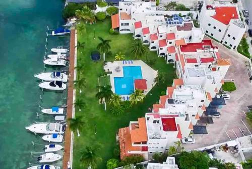 an aerial view of a resort with boats in the water at Mexican Lagoon front Villa by CASA PARAISO in Cancún
