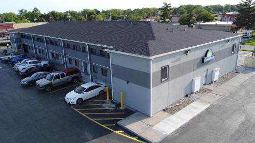 an overhead view of a building with cars parked in a parking lot at Days Inn by Wyndham Indianapolis East Post Road in Indianapolis