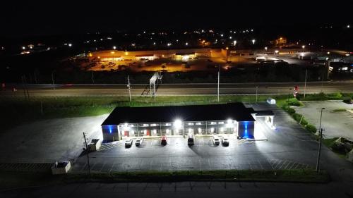 a building with a parking lot at night at Days Inn by Wyndham Indianapolis East Post Road in Indianapolis