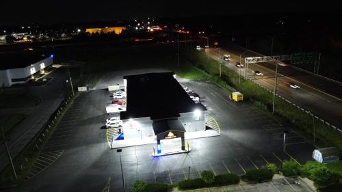 a building in a parking lot at night at Days Inn by Wyndham Indianapolis East Post Road in Indianapolis