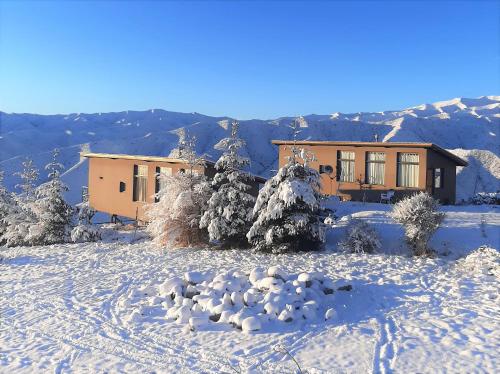 a house in the snow with footprints in the snow at ArribadelValle - Casas de Altura in Potrerillos
