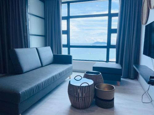 a living room with a couch and a large window at KEEN Suites-Jesselton Quay in Kota Kinabalu