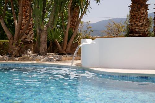 a swimming pool with a water fountain at Xenos Villa 2 With 5 Bedrooms private swimming pool, near the sea in Tigaki