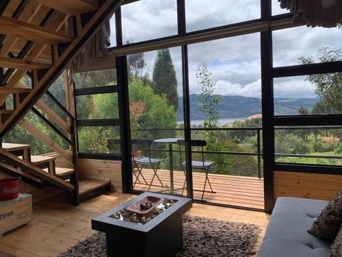 a living room with a large window with a view at Mirador Valeisa in Guatavita