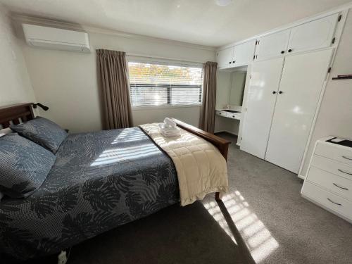 a bedroom with a bed and a window at Flat Rock in Lake Tekapo
