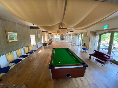 a room with a pool table and chairs at The Old Flax Mill Yoga Retreat in Coleraine