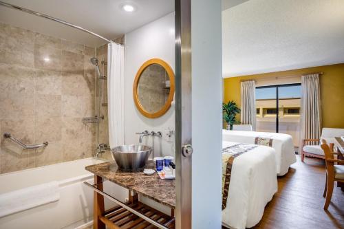 a hotel room with a bed and a bathroom at Guam Plaza Resort in Tumon