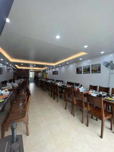 a dining room with wooden tables and chairs at An Cường Hotel in Sầm Sơn