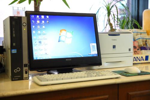 a computer monitor and a keyboard and mouse on a desk at Nagasaki IK Hotel in Nagasaki