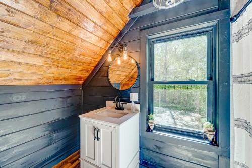 a bathroom with a sink and a window at Rustic Oasis in Ellijay