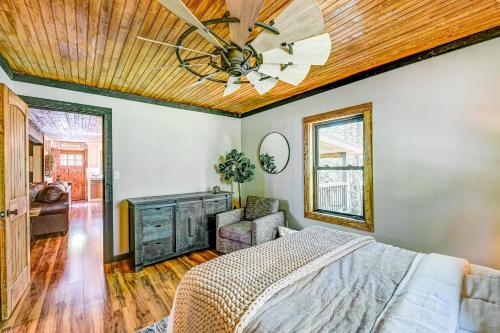 a bedroom with a ceiling fan and a bed at Rustic Oasis in Ellijay