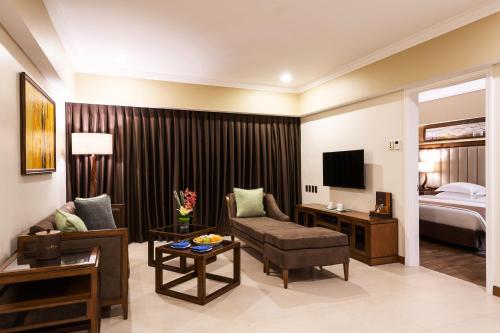 a living room with a couch and a bed at Jpark Island Resort & Waterpark Cebu in Mactan