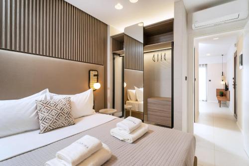 a bedroom with a bed with two towels on it at Acantha Suites in Skala Potamias