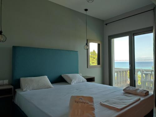 una camera con letto e vista sull'oceano di Hotel Paraktio a Nea Kalikratia