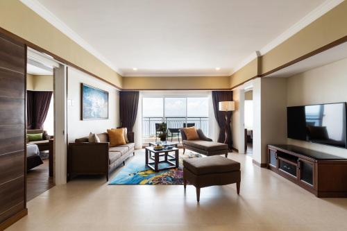 a living room with a couch and a television at Jpark Island Resort & Waterpark Cebu in Mactan