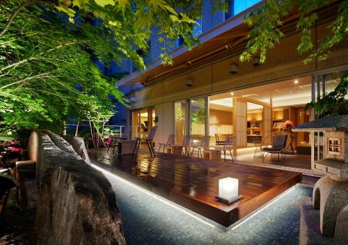 an indoor garden with a wooden bench in the middle of a house at Hotel Niwa Tokyo in Tokyo
