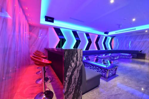a nightclub with pink and blue lighting and a bar at W3 MOTEL in Luzhu