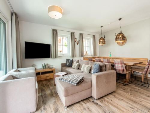 a living room with a couch and a table at Holiday home in Niedernsill with sauna in Niedernsill