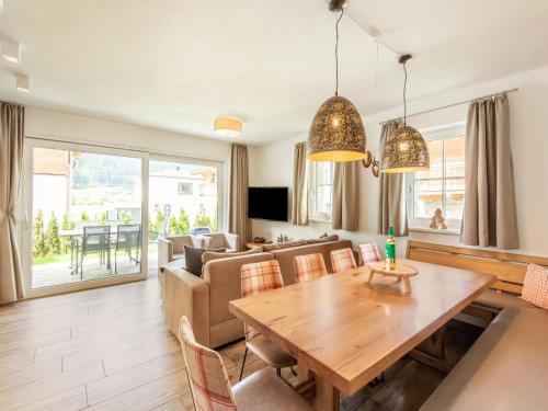 een woonkamer met een tafel en een bank bij Holiday home in Niedernsill with sauna in Niedernsill