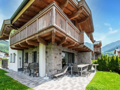 a large deck on a house with a patio at Luxurious holiday home with sauna in Niedernsill Salzburgerland in Niedernsill