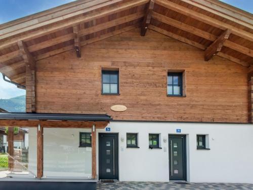 a house with a wooden roof at Luxurious holiday home with sauna in Niedernsill Salzburgerland in Niedernsill