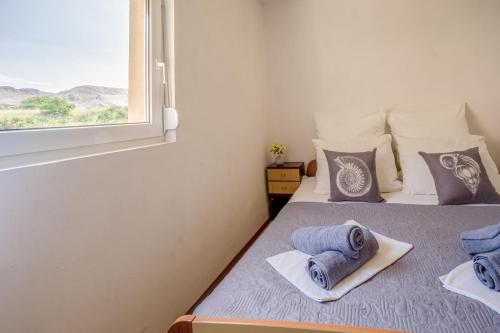 a bedroom with a bed with towels on it at Asta view over sea reed landscape and bay in Metajna