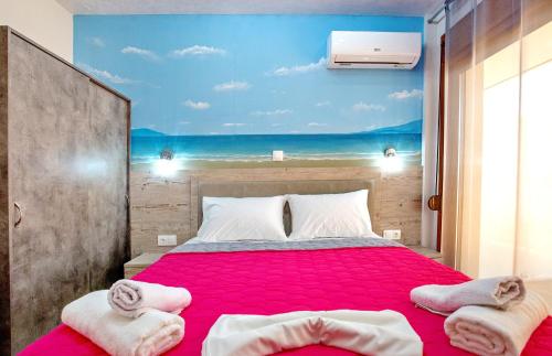 a bedroom with a bed with a view of the beach at RENT HOUSE ANEMOS in Iraklitsa