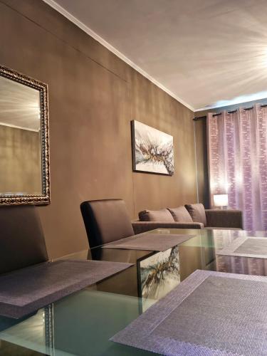 a living room with a glass table and chairs at Island Club by Smart City Stays in Cape Town