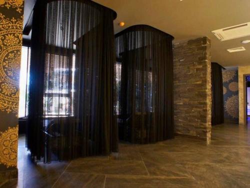 a room with black curtains and a brick wall at Via Mar Residence - Alanya Experience in Alanya