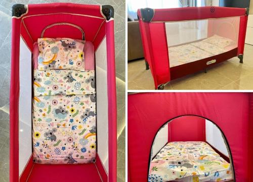 a red crib with a bed inside of it at Via Mar Residence - Alanya Experience in Alanya