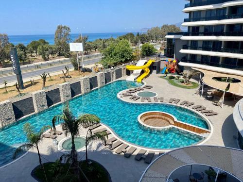 a swimming pool with a slide on a building at Via Mar Residence - Alanya Experience in Alanya