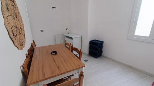 a dining room with a wooden table and chairs at La Dea del Mare in Ischia