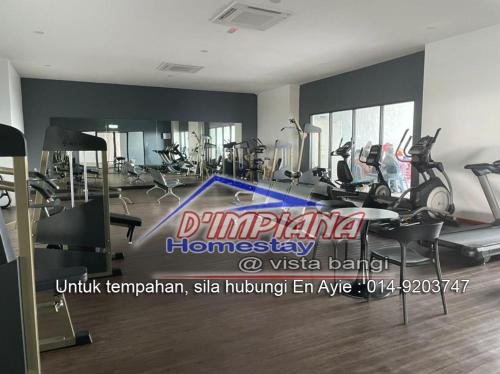 a gym with treadmills and elliptical machines at D’Impiana Homestay @Vista Bangi in Kajang